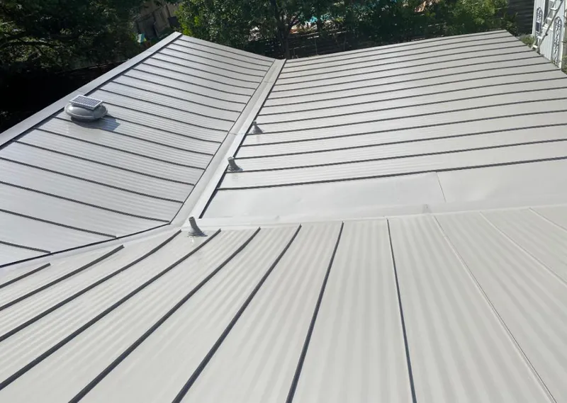 Solar attic fan installed on a metal roof for Roof Ventilation in Nashville